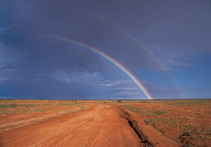 A double rainbow goes over an outback track